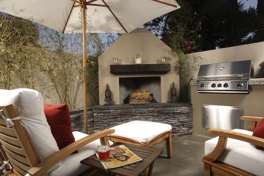 Outdoor kitchen and fireplace on a stone patio