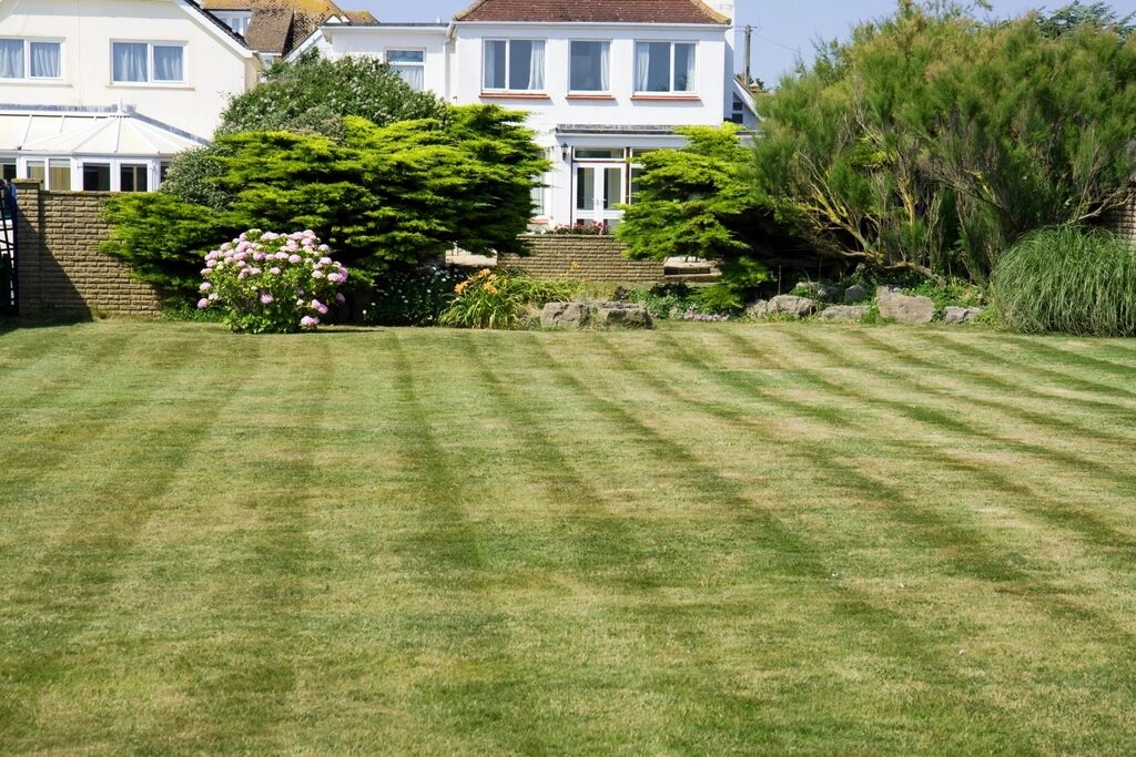 Striped green lawn in front of a home