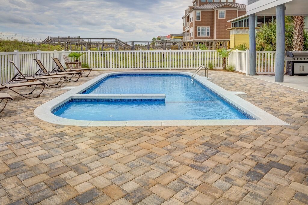 Paver deck around a backyard pool