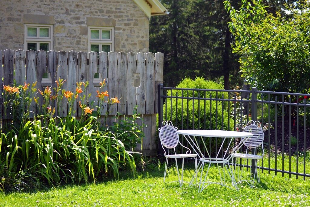 Perennial garden beside a fenced patio